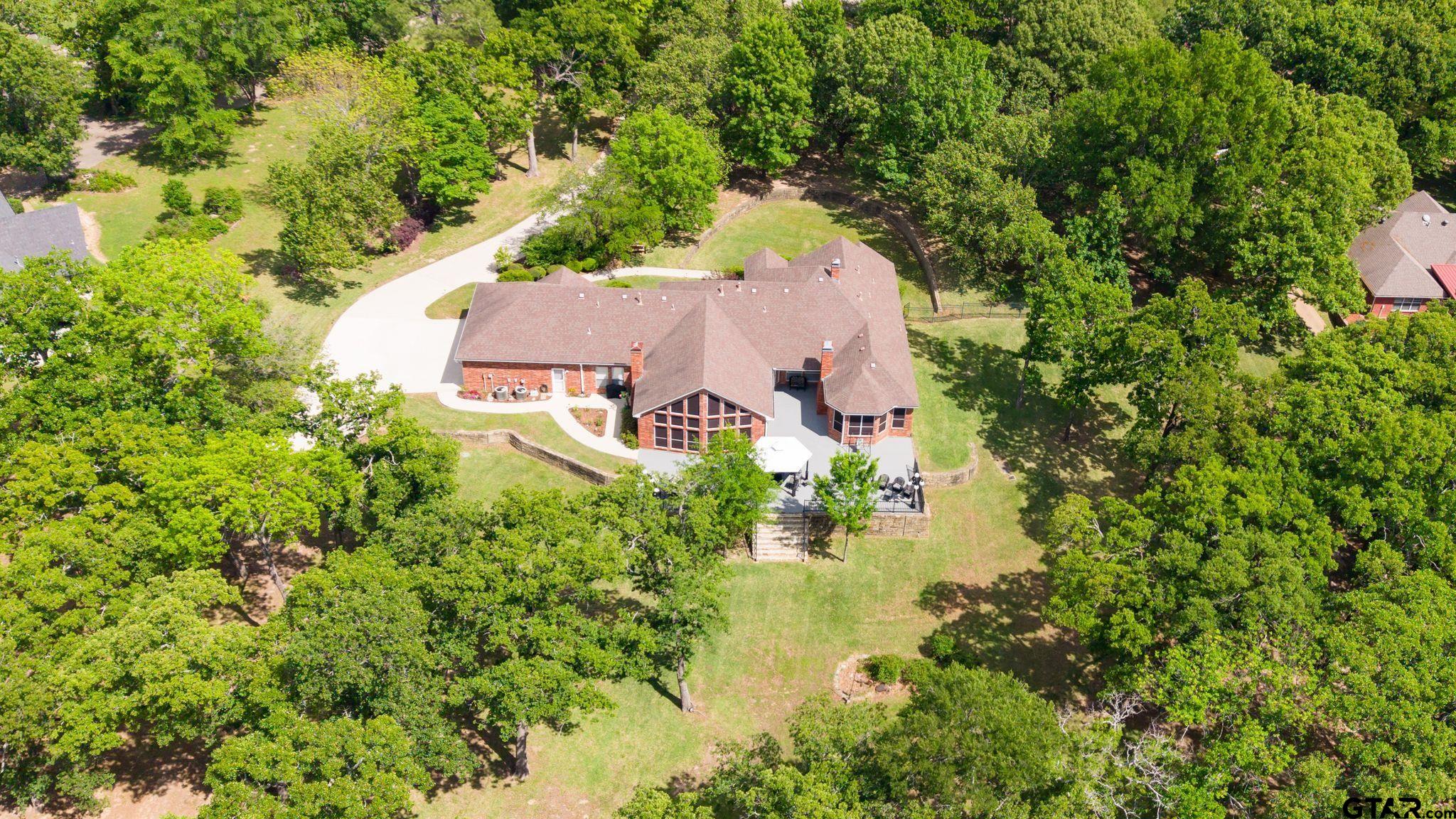 511 Rcr 3346 Emory, TX 75440 - Photo 9 of 48 an aerial view of a house with a yard lake and trees all around