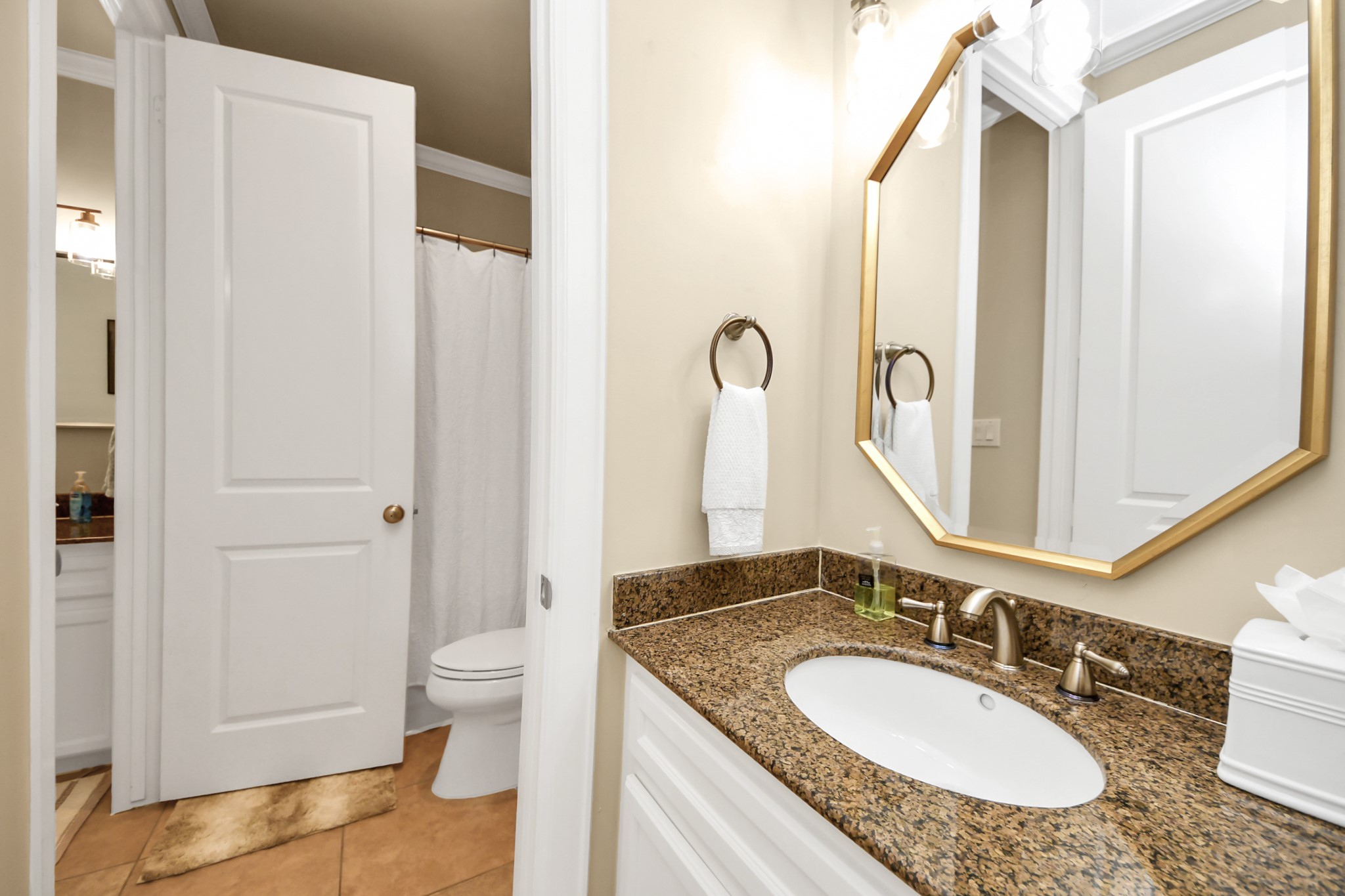 6302 Hermann Lake Drive Houston, TX 77021 - Photo 33 of 50 This well-appointed secondary bathroom features a granite vanity countertop, elegant fixtures, and a bright mirror that enhances the sense of space and light.