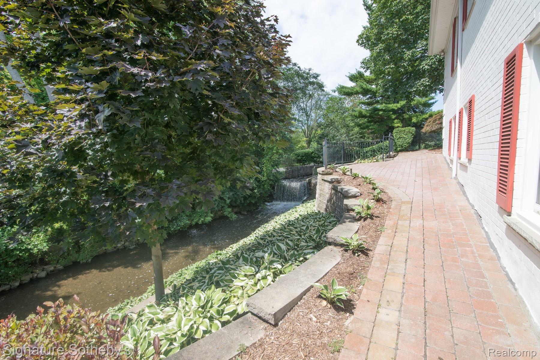 172 Chesterfield Road Bloomfield Hills, MI 48304 - Photo 68 of 98 026_37.jpg West side of home with waterfall and rows and rows of Hosta's