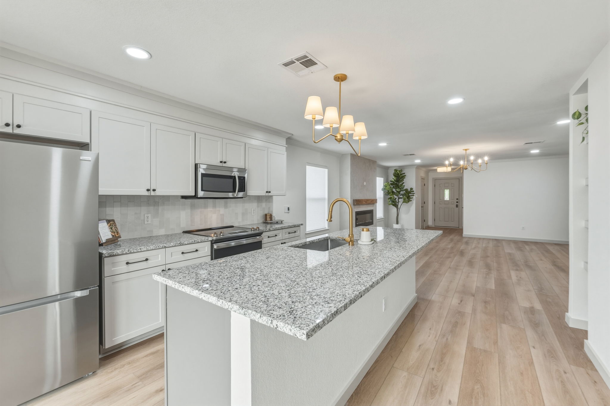 211 Banner Avenue Leander, TX 78641 - Photo 4 of 27 a kitchen with a center island appliances and cabinets