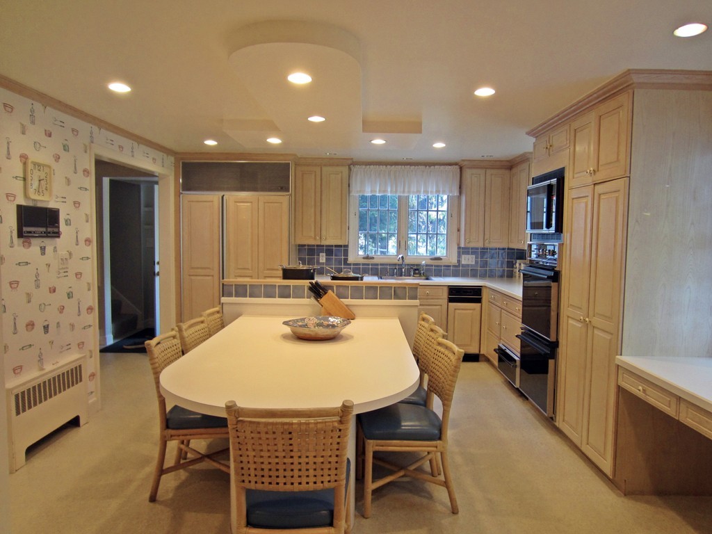 44 Ridge Hill Farm Road Wellesley, MA 02482 - Photo 10 of 30 a kitchen with a table chairs refrigerator and microwave