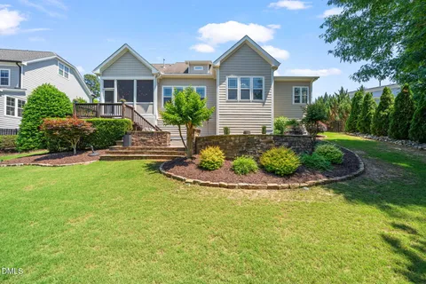 a front view of a residential houses with yard and green space
