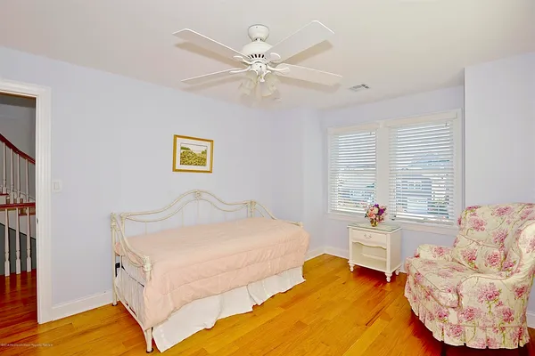 a bedroom with a bed and ceiling fan