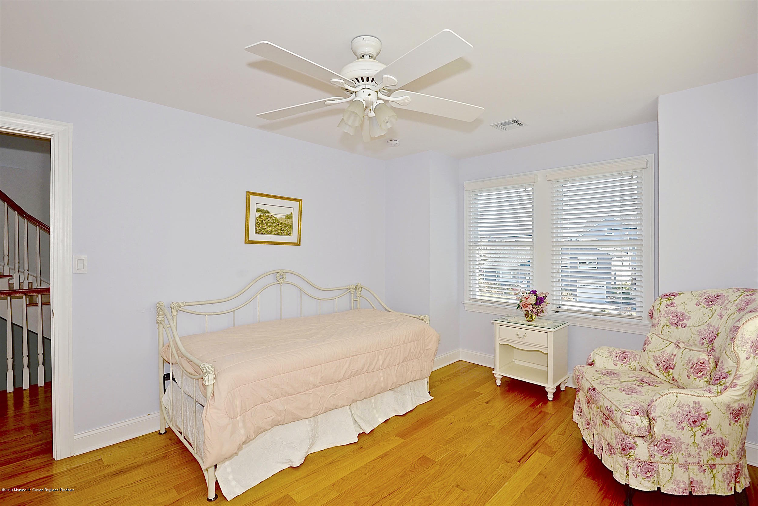 209 1st Avenue Spring Lake, NJ 07762 - Photo 11 of 19 a bedroom with a bed and ceiling fan