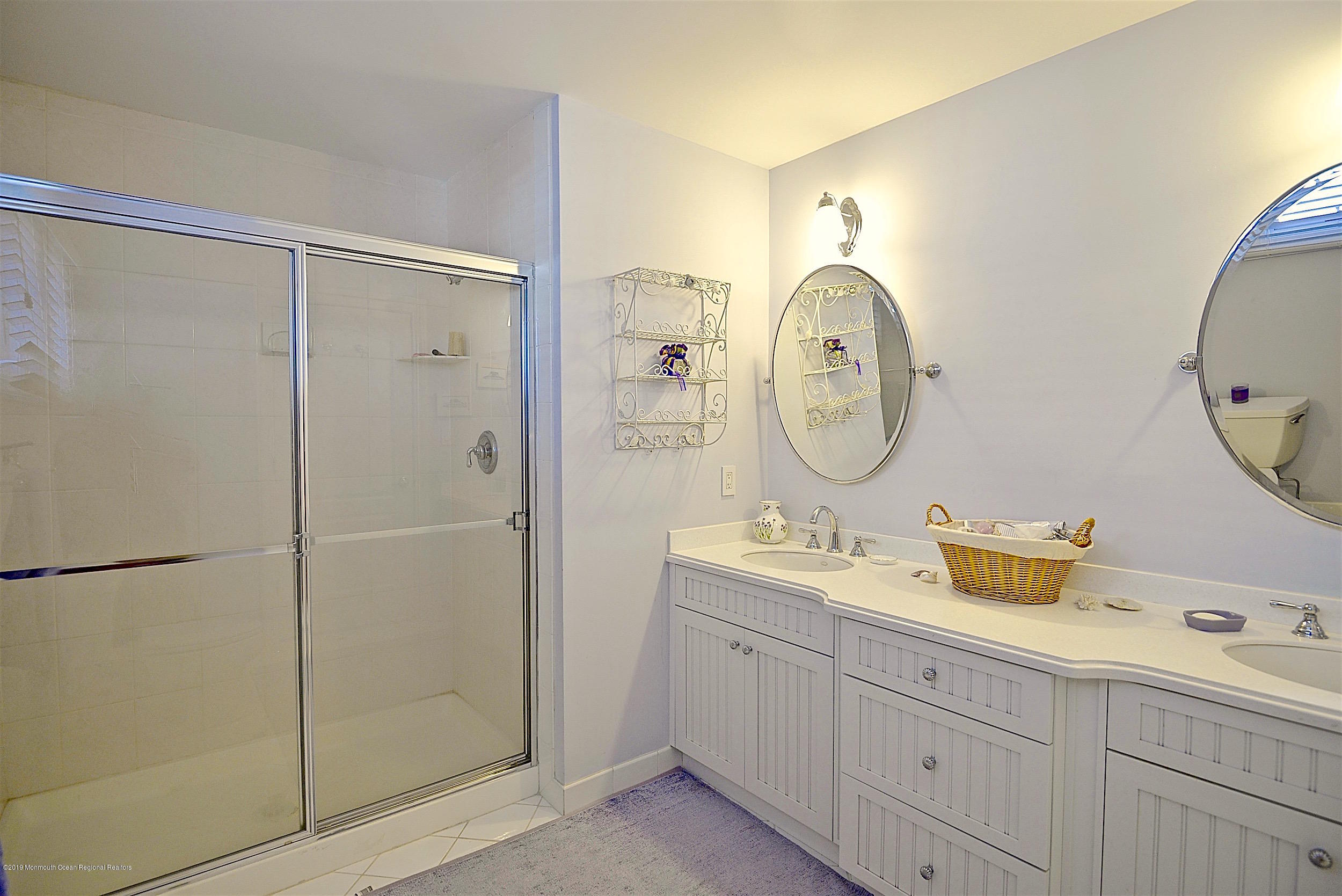 209 1st Avenue Spring Lake, NJ 07762 - Photo 14 of 19 a bathroom with a double vanity sink mirror and shower