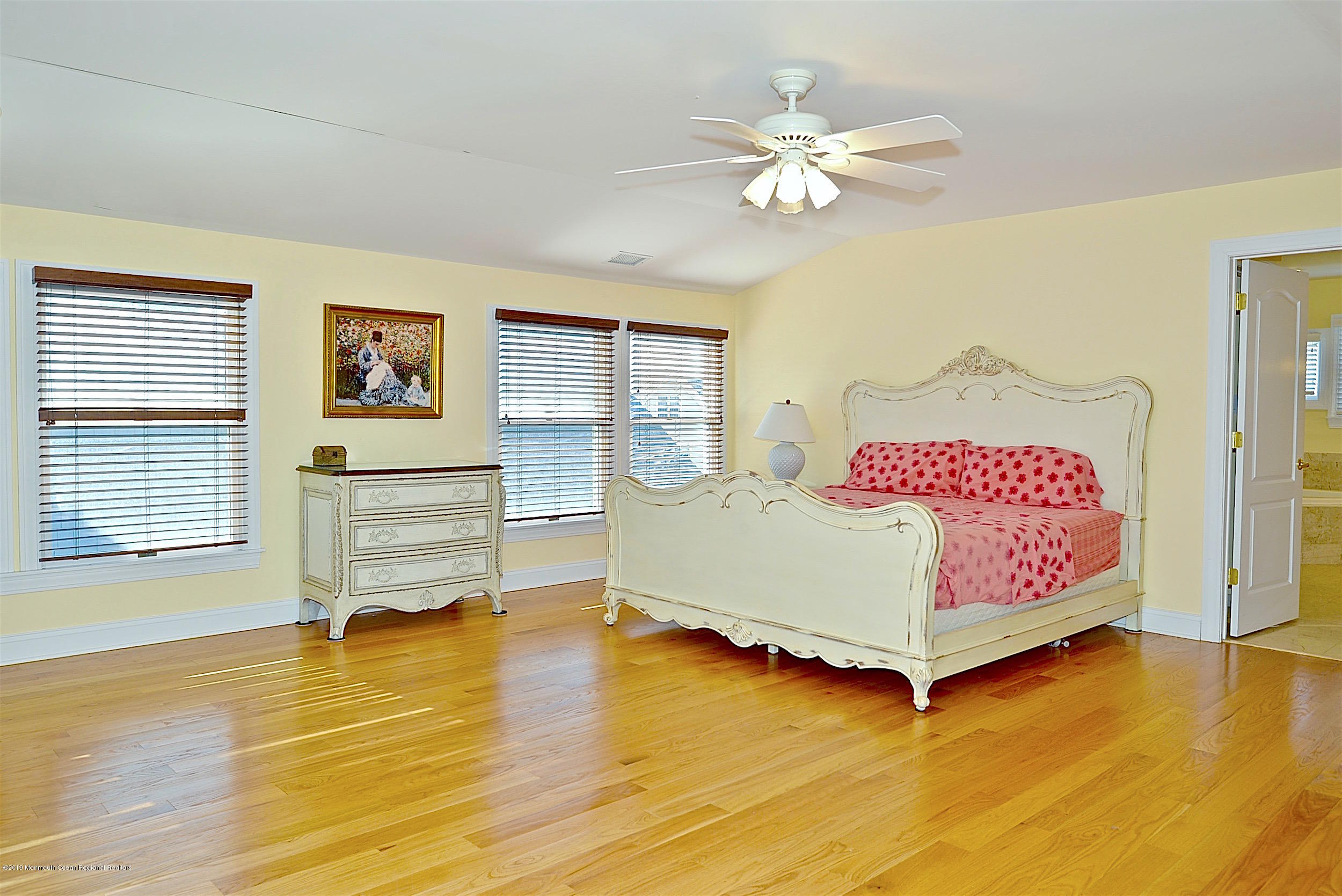 209 1st Avenue Spring Lake, NJ 07762 - Photo 15 of 19 a bedroom with a bed and wooden floor