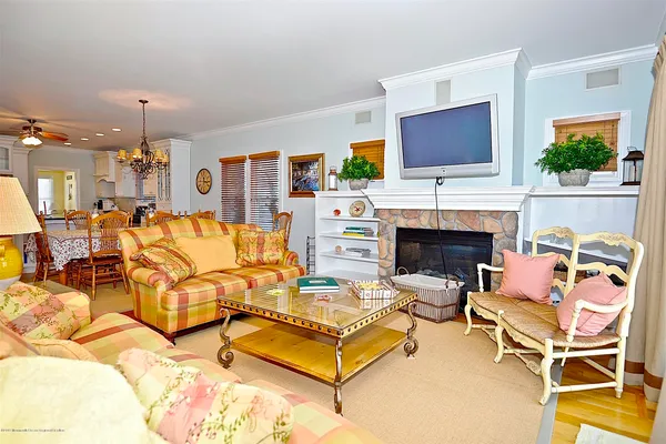a living room with furniture fireplace and flat screen tv