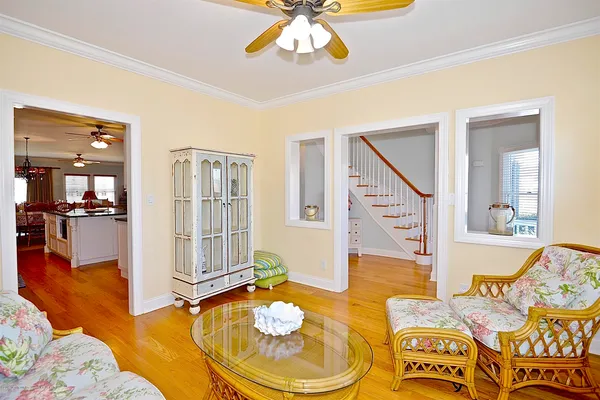 a living room with furniture and a wooden floor