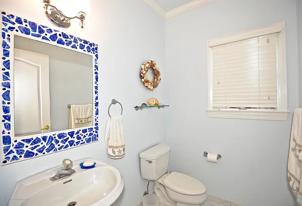 a bathroom with a sink mirror and toilet