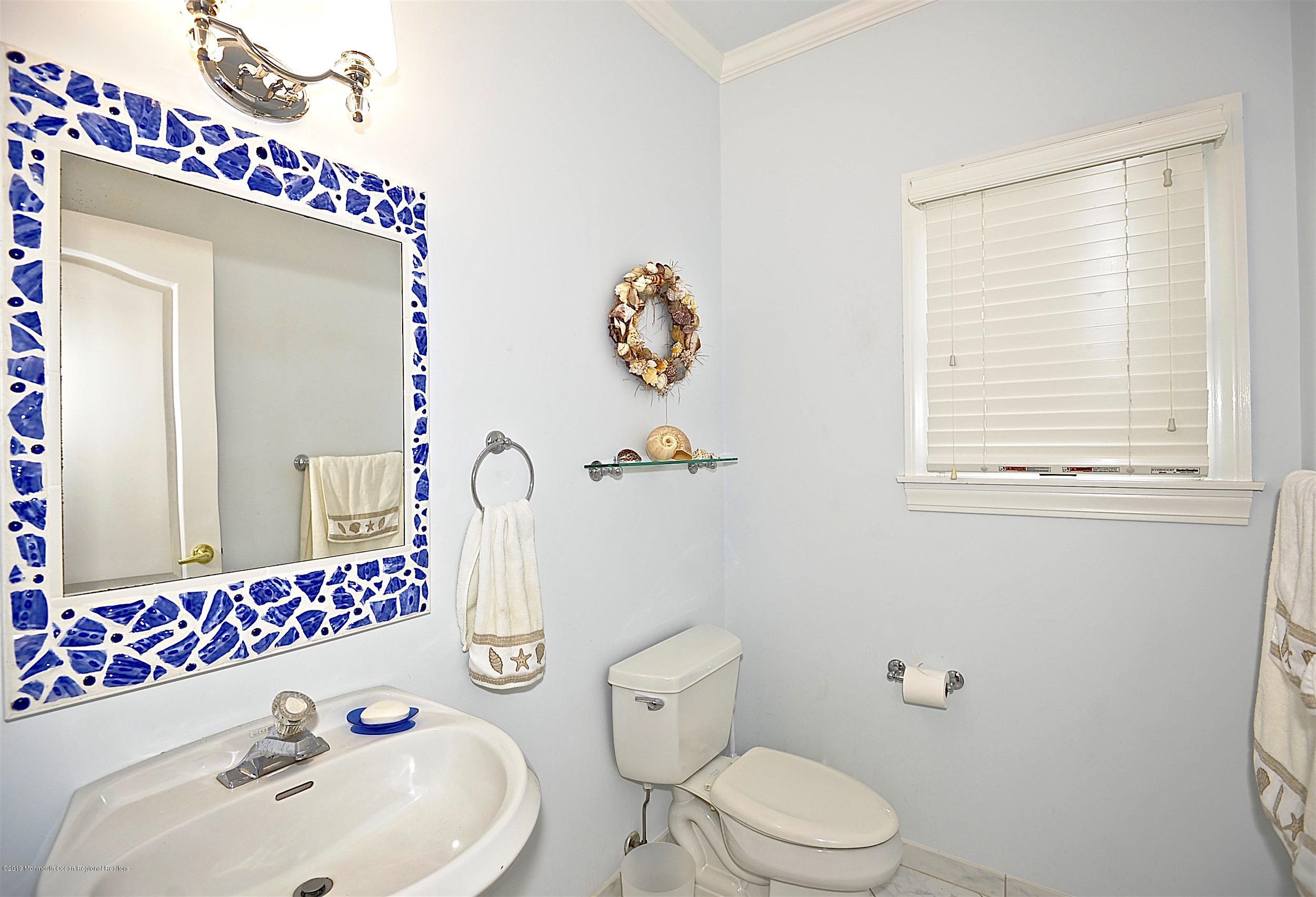 209 1st Avenue Spring Lake, NJ 07762 - Photo 19 of 19 a bathroom with a sink mirror and toilet