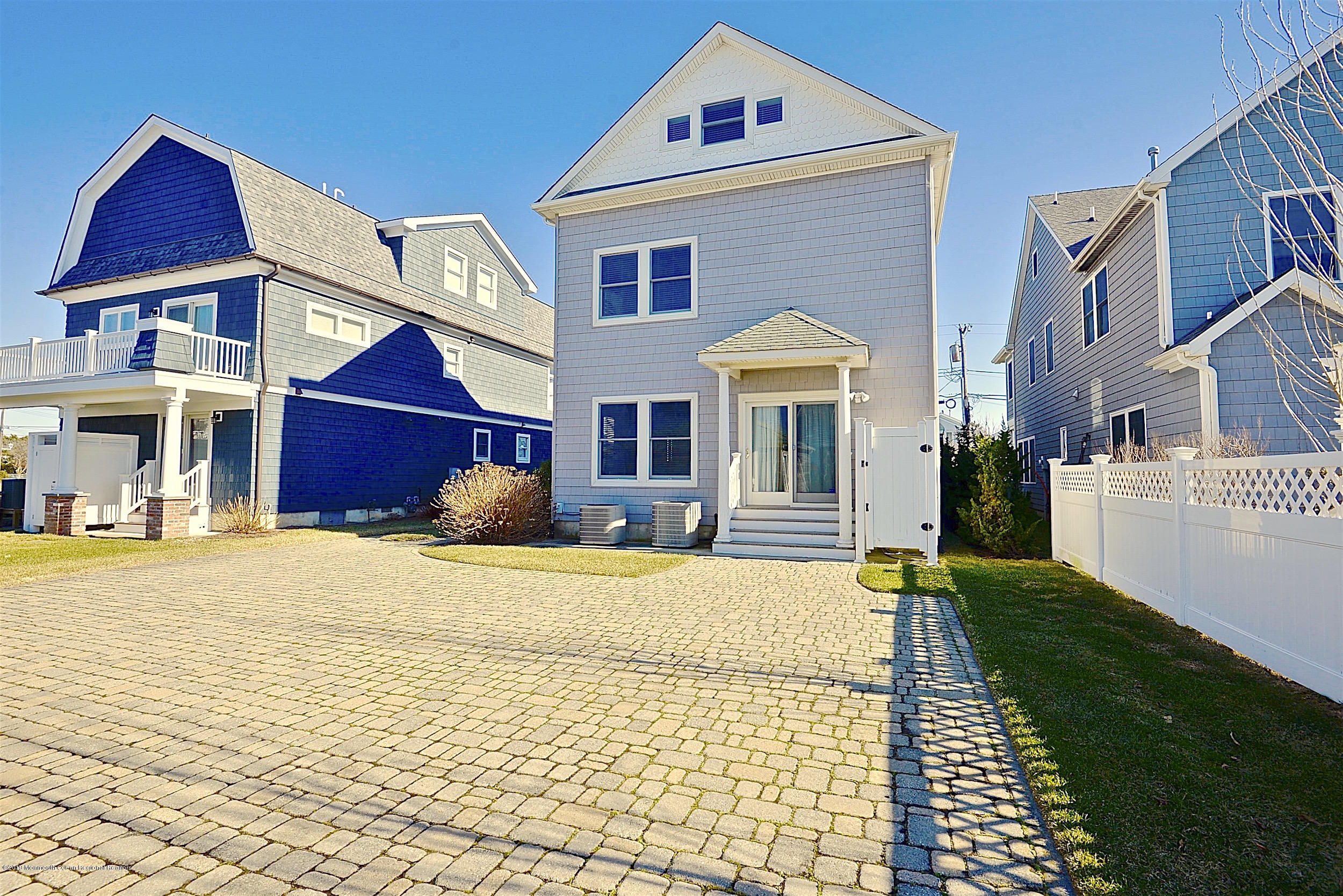 209 1st Avenue Spring Lake, NJ 07762 - Photo 2 of 19 a front view of a house with a yard and garage