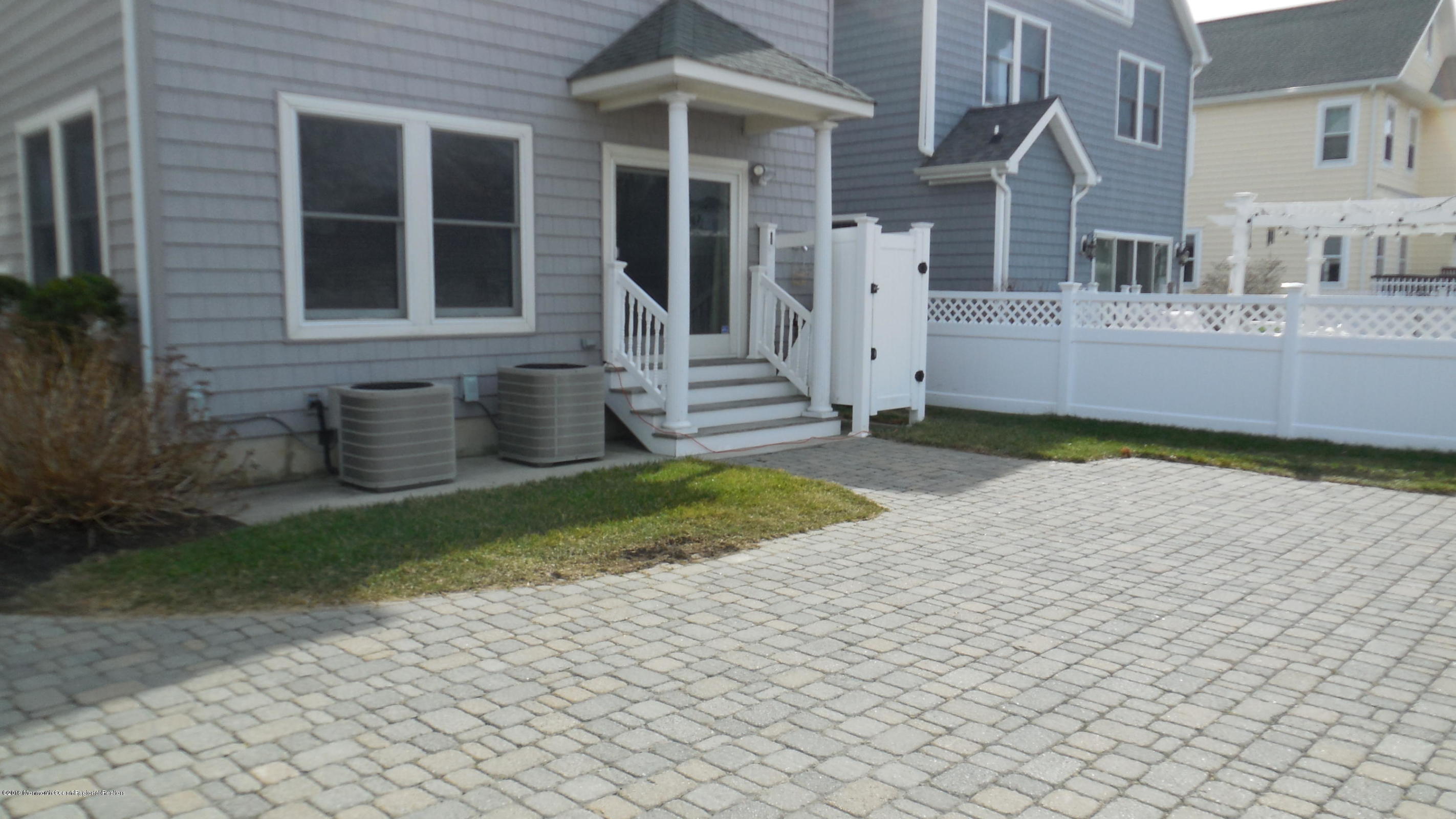 209 1st Avenue Spring Lake, NJ 07762 - Photo 3 of 19 a front view of a house with a yard