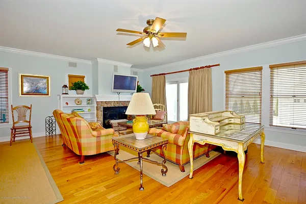a living room with fireplace furniture and a large window