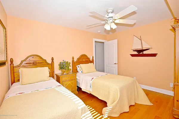 a bedroom with 2 bed and a chandelier