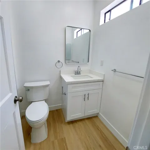 a bathroom with a sink toilet and a mirror