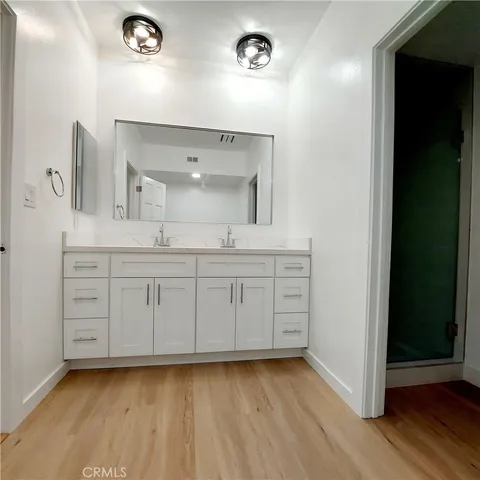 a bathroom with a sink a mirror and a vanity