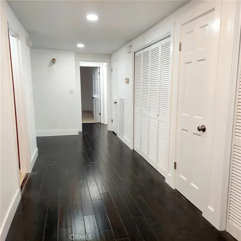 a view of a hallway with wooden floor