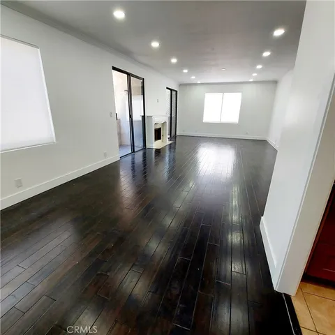 an entryway in a hall with wooden floor