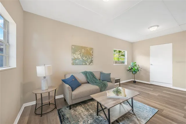a living room with furniture and wooden floor