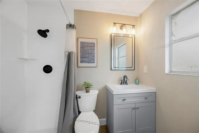 a bathroom with a toilet sink and mirror