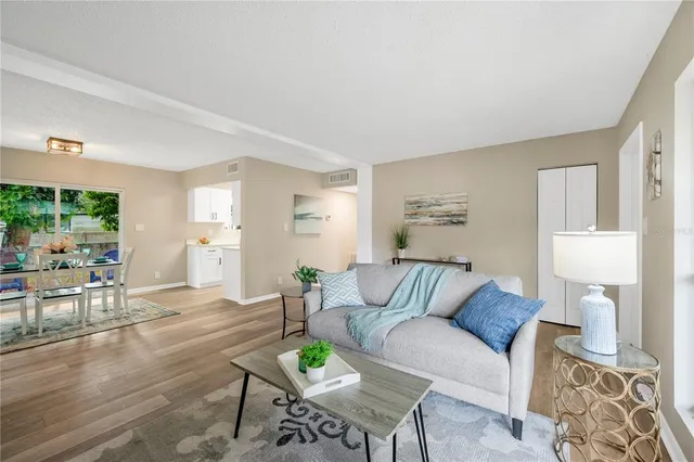 a living room with furniture and wooden floor