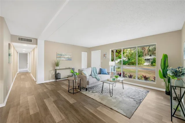 a living room with furniture and a large window