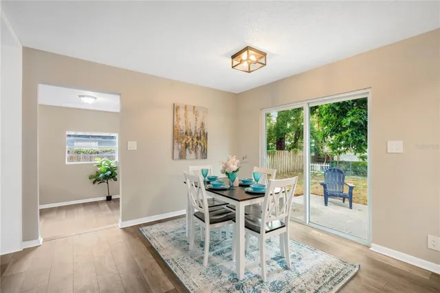 a dining room with furniture and wooden floor