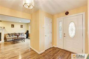 18 Devon Road Edison, NJ 08820 - Photo 3 of 25 a view of a livingroom with furniture a chandelier and wooden floor