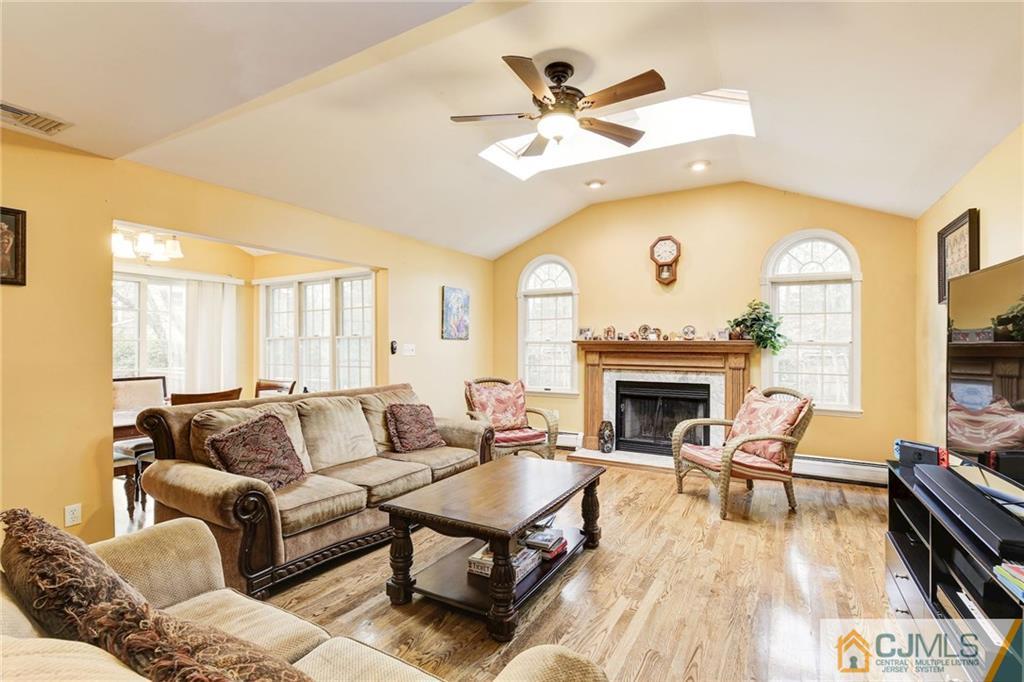 18 Devon Road Edison, NJ 08820 - Photo 4 of 25 a living room with furniture a fireplace and a large window