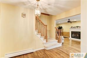 18 Devon Road Edison, NJ 08820 - Photo 5 of 25 a view of a livingroom with wooden floor and a fireplace