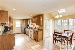 18 Devon Road Edison, NJ 08820 - Photo 10 of 25 a large kitchen with a table and chairs in it