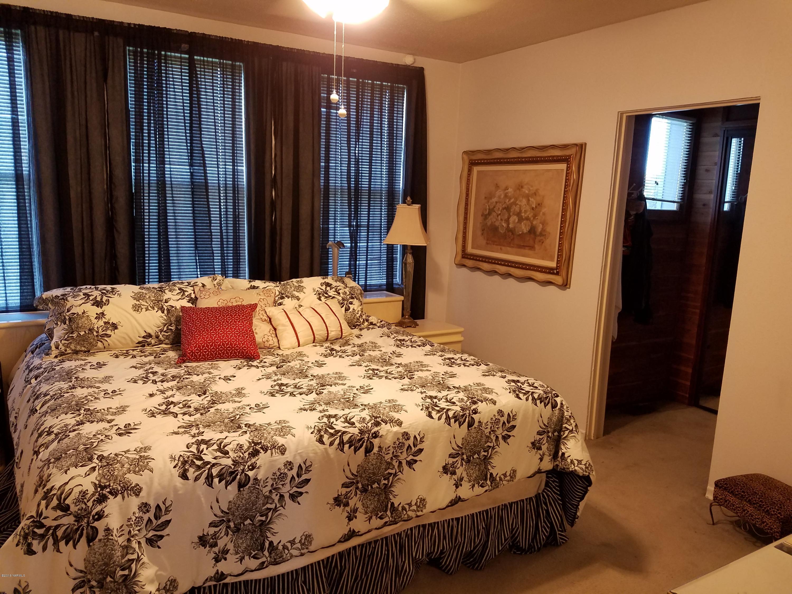 650 White Road Zillah, WA 98953 - Photo 11 of 17 a bedroom with a bed and wooden floor