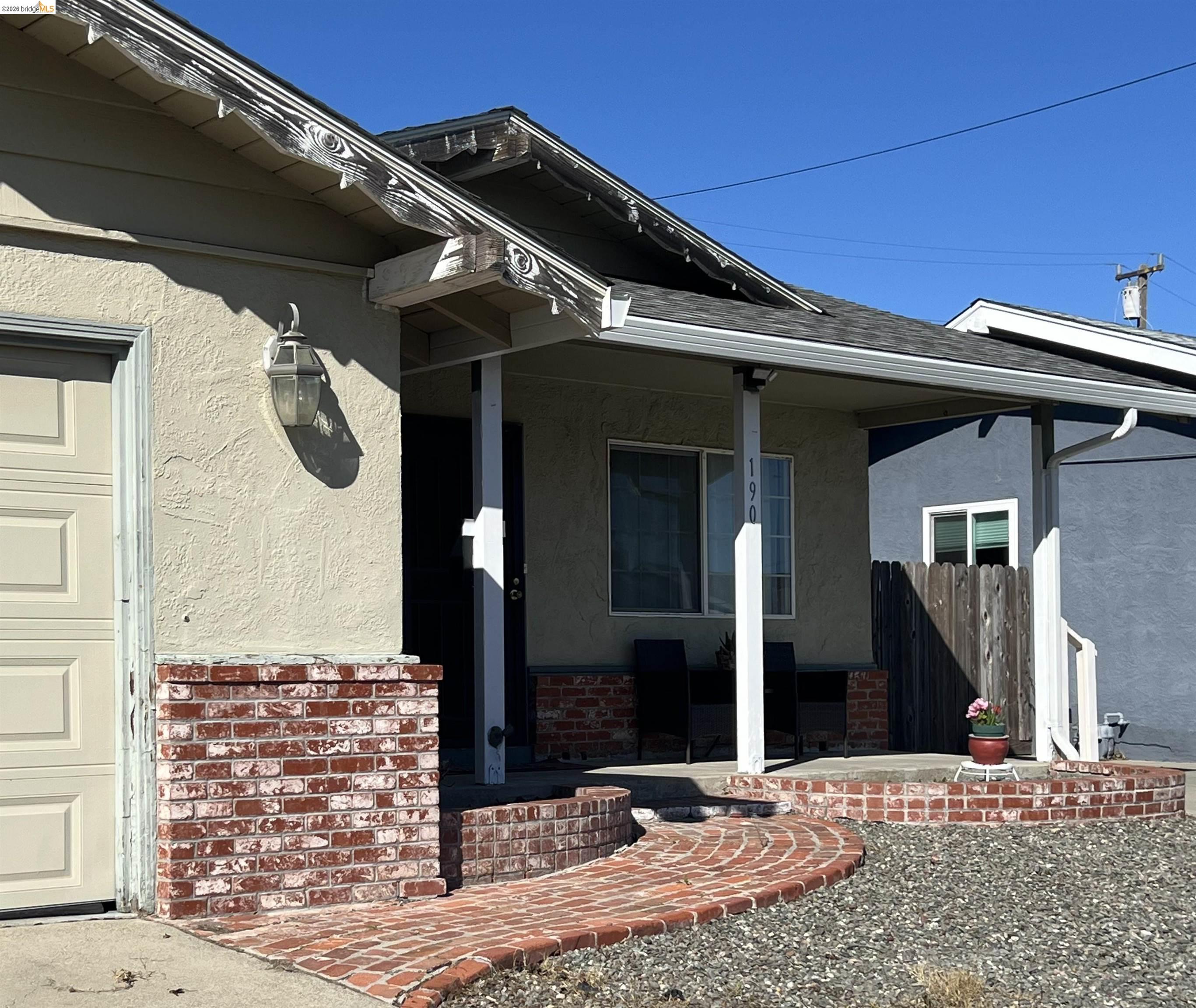 190 Tahoe Drive Rio Vista, CA 94571 - Photo 3 of 44 Entrance to property featuring stucco siding, a porch, a garage, and a shingled roof
