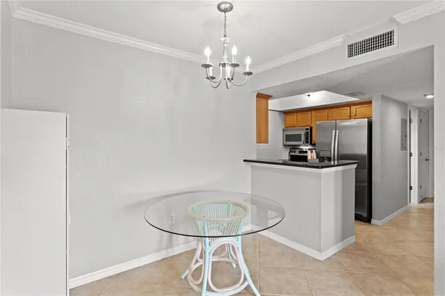 a view of a kitchen with a sink and a chandelier
