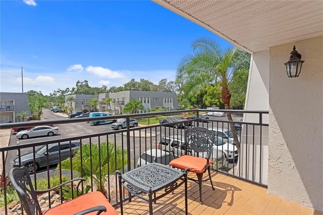 a view of a balcony with wooden floor and fence
