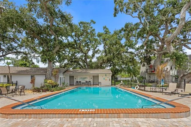 a view of a house with swimming pool and sitting area