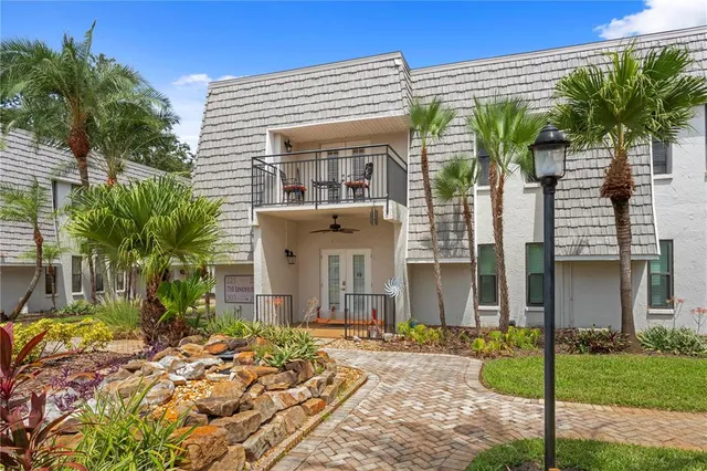 a street sign on a road next to a building