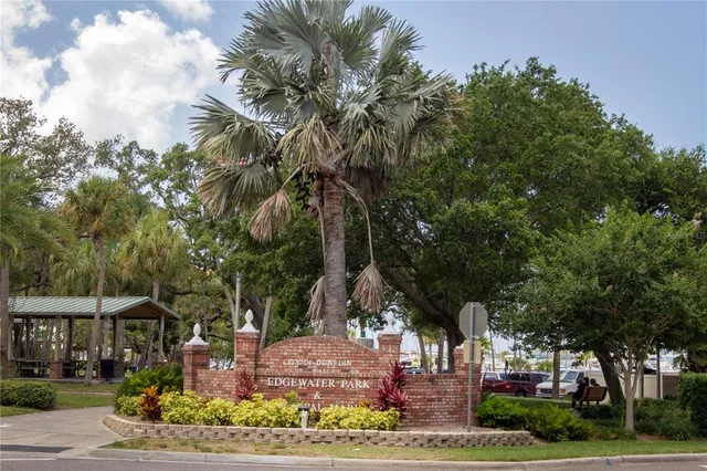 a view of a street with potted plants