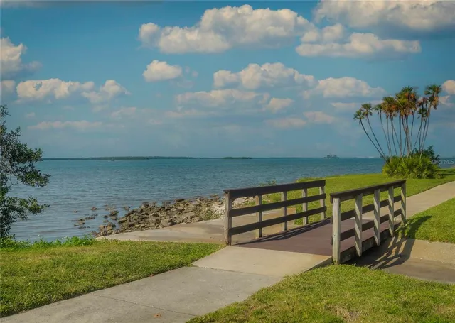 a view of a swimming pool with a bench and wooden fence