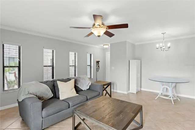 a living room with furniture and a chandelier
