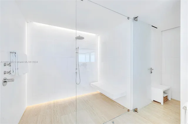 a bedroom with a bed and large windows