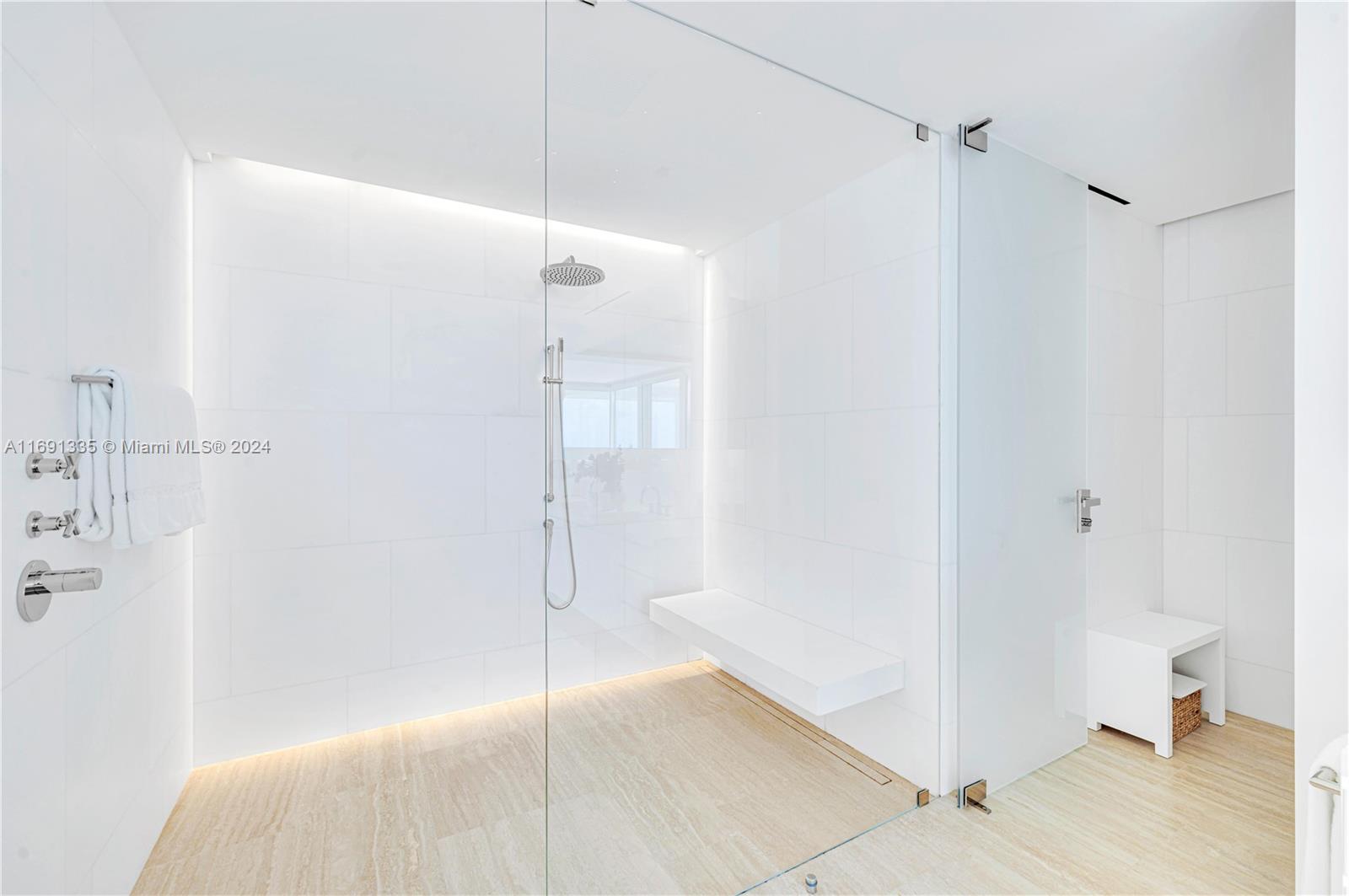 9111 Collins Avenue, Unit NPH6 Surfside, FL 33154 - Photo 29 of 66 a bathroom with a shower and a glass door