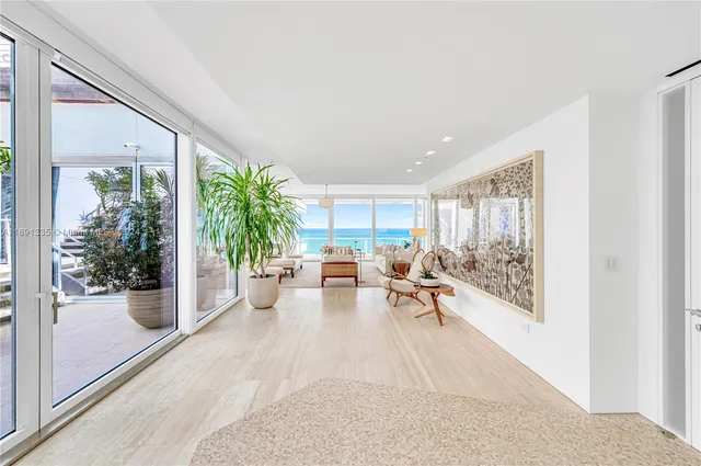 a living room with furniture and a potted plant