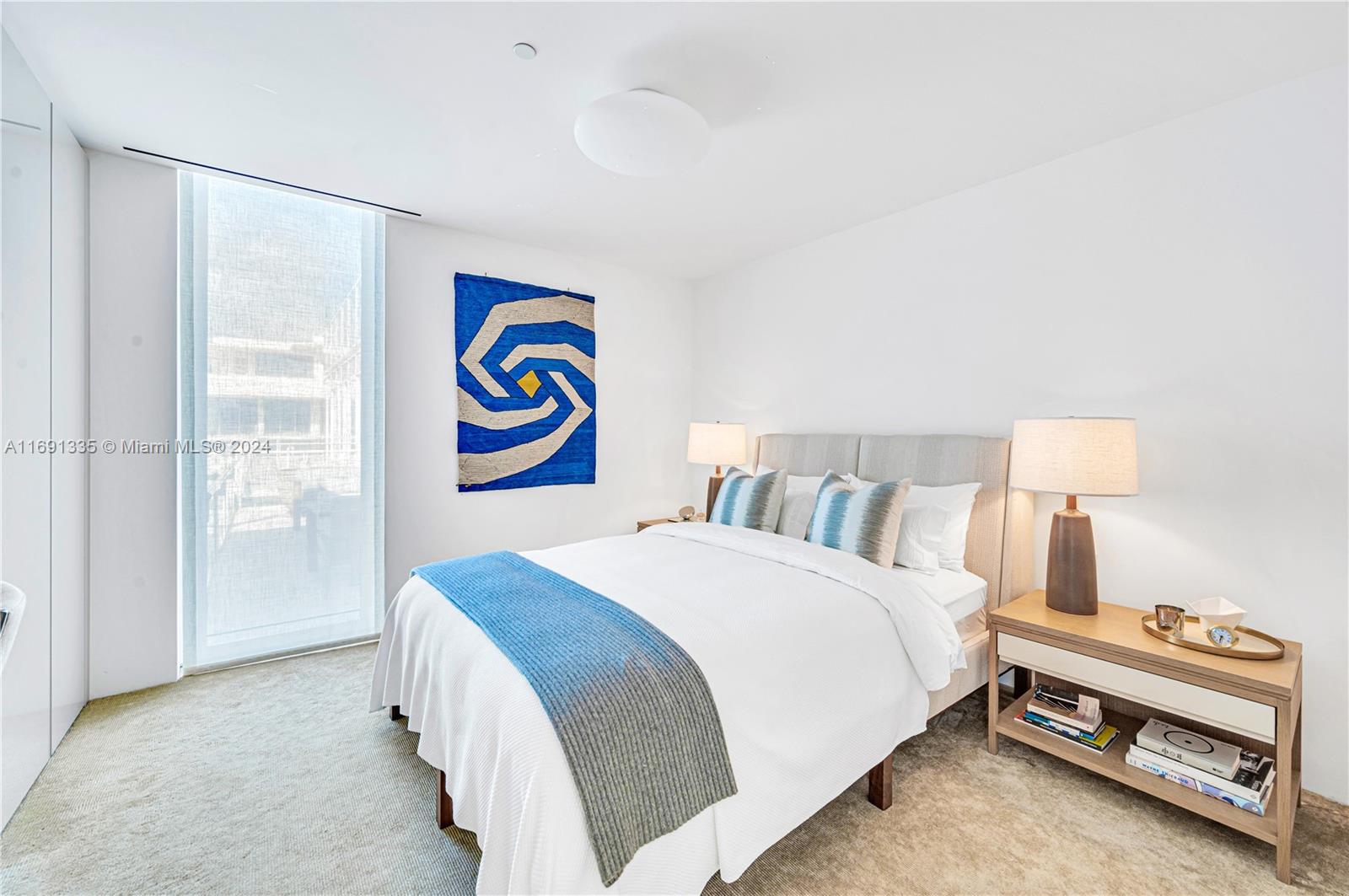 9111 Collins Avenue, Unit NPH6 Surfside, FL 33154 - Photo 40 of 66 a bedroom with a bed and a lamp next to a window