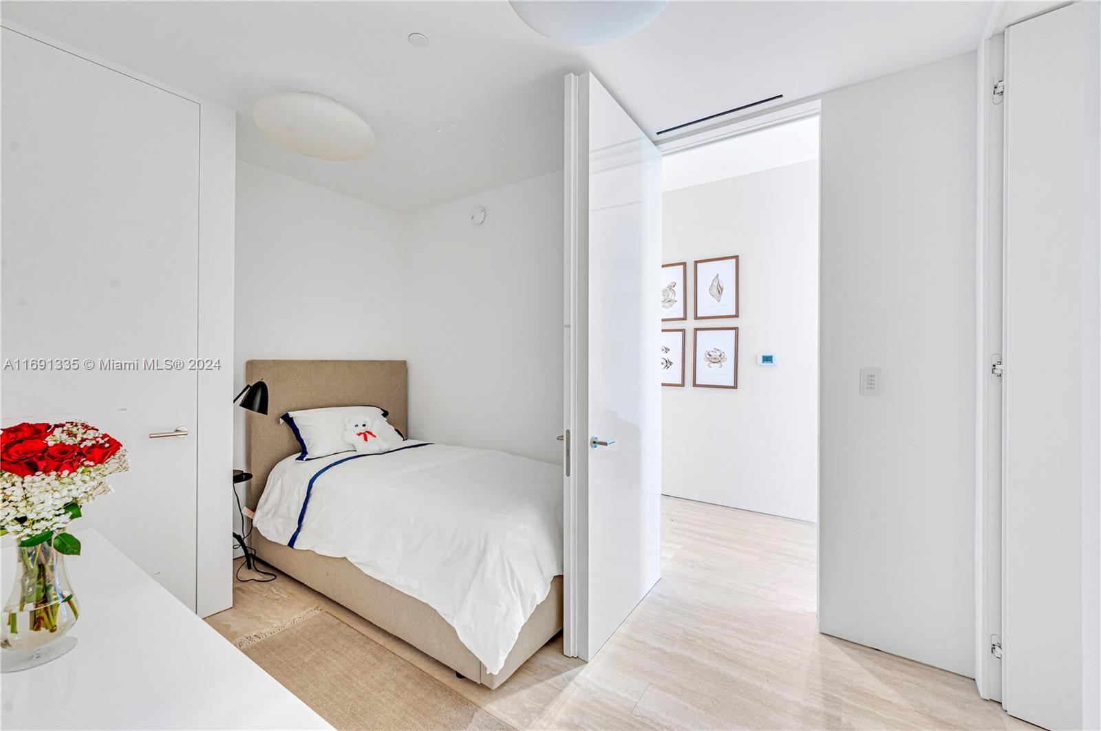 9111 Collins Avenue, Unit NPH6 Surfside, FL 33154 - Photo 43 of 66 a bedroom with a bed and a potted plant