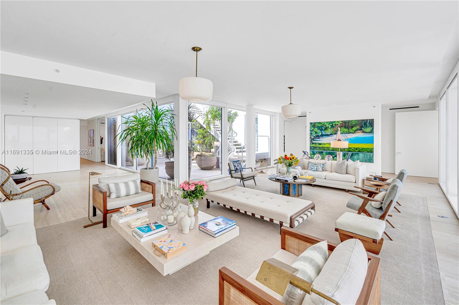 9111 Collins Avenue, Unit NPH6 Surfside, FL 33154 - Photo 6 of 66 a living room with furniture and a chandelier