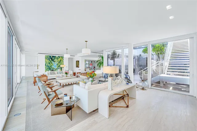 a living room with furniture and a table with wooden floor