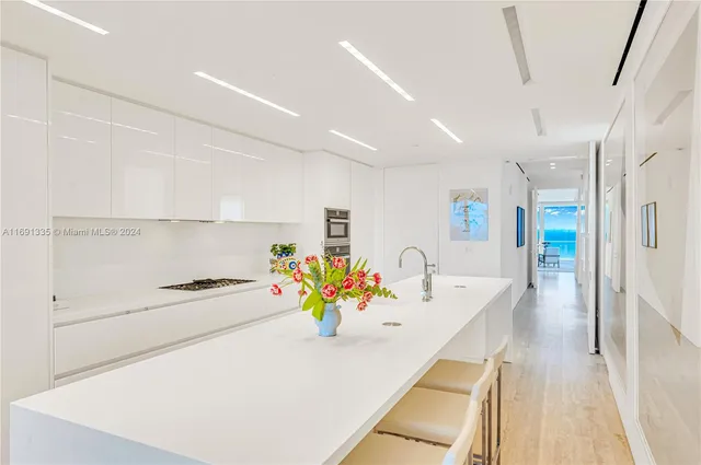 a kitchen with stainless steel appliances cabinets and wooden floor