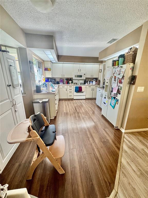 6812 Arbor Oaks Drive Bradenton, FL 34209 - Photo 11 of 29 a living room with furniture and a wooden floor