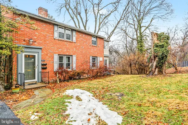 a view of a house with snow on the roadside
